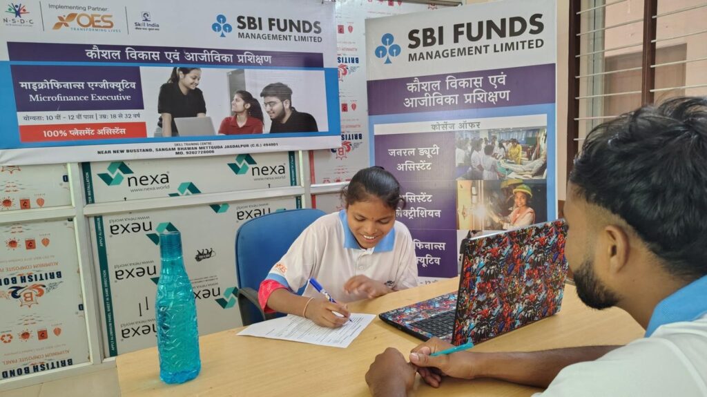 A female learner completing her skill training enrolment form at an OES centre operating under the NSDC Skill India programme in India