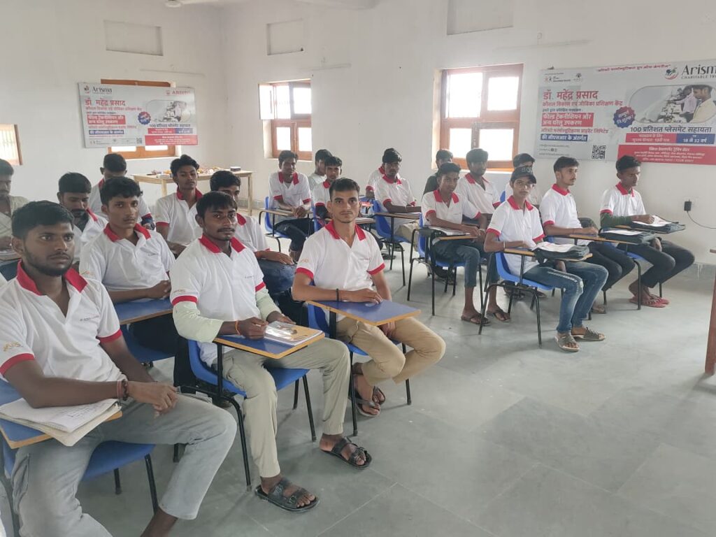 A full batch of male youth trainees seated in a vocational training classroom at an OES affiliated skill development centre in India